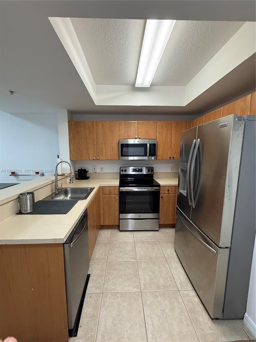 119 Southwest 6th Avenue, Unit 405 Miami, FL 33130 - Photo 4 of 23 a kitchen with granite countertop a refrigerator and a stove