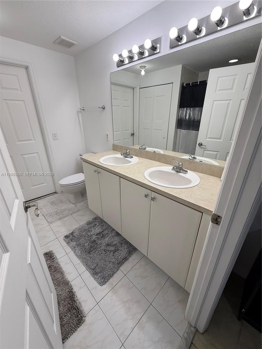 119 Southwest 6th Avenue, Unit 405 Miami, FL 33130 - Photo 10 of 23 a bathroom with a sink a vanity and a mirror