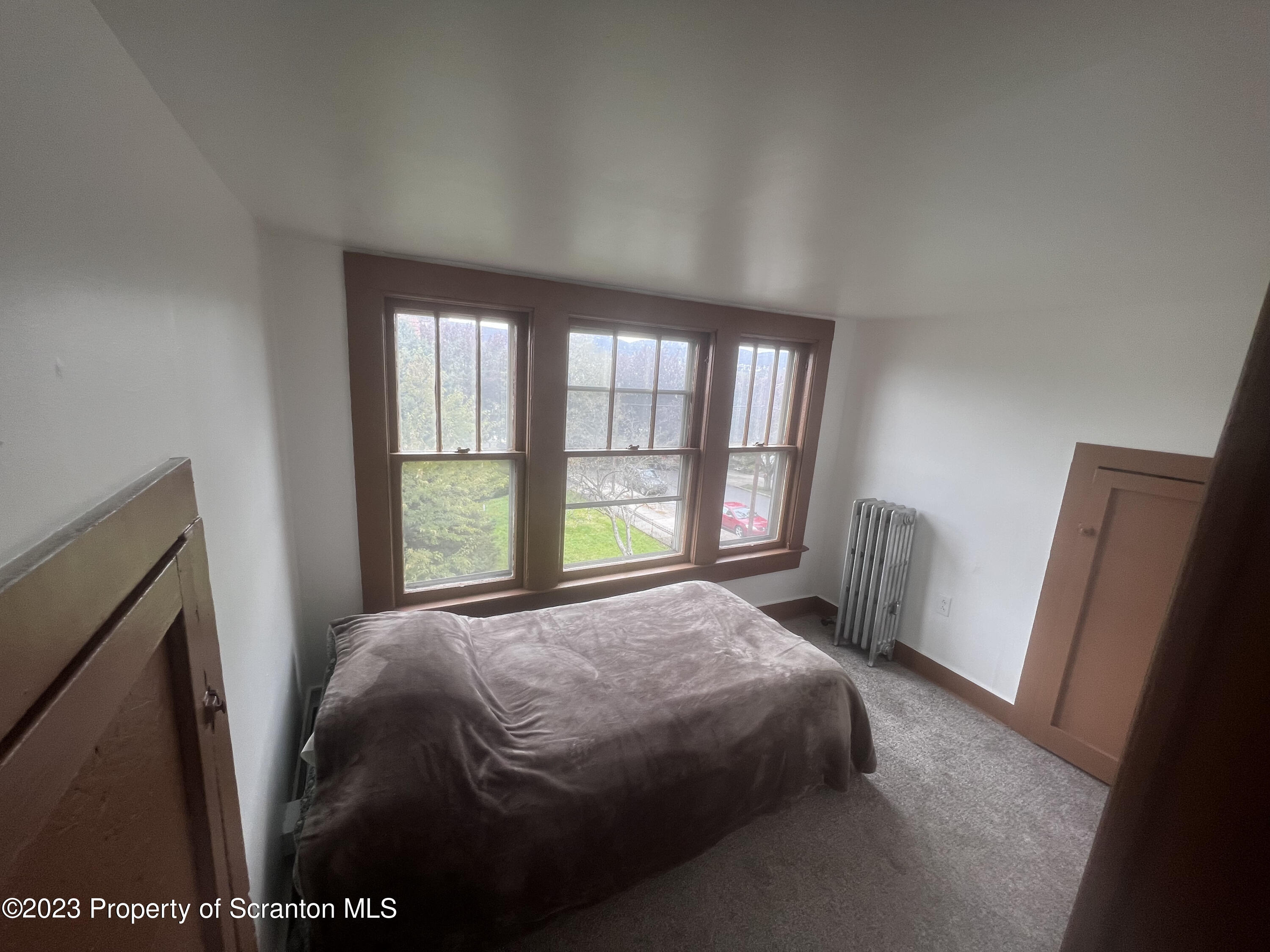 534 Fig Street, Unit 3 Scranton, PA 18505 - Photo 4 of 8 a bedroom with a bed next to a window