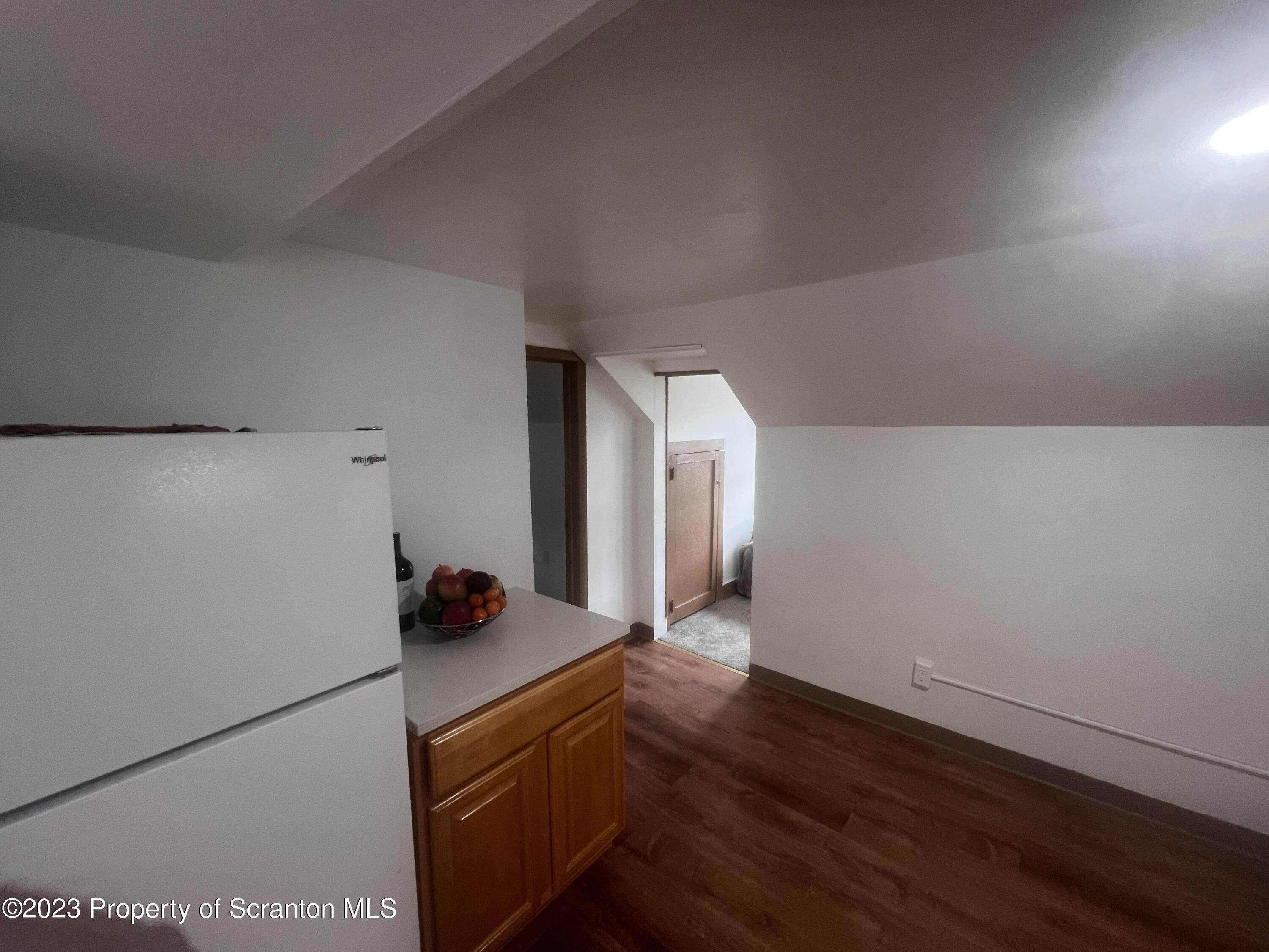 534 Fig Street, Unit 3 Scranton, PA 18505 - Photo 6 of 8 a kitchen with a refrigerator and wooden floor