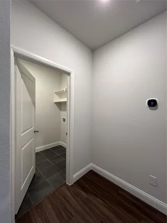 a view of a room with wooden floor and a sink