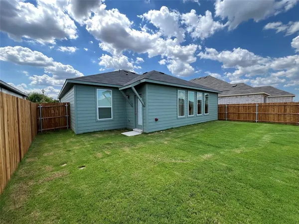a view of a backyard with a large tree