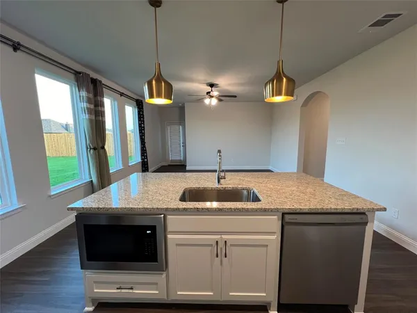 a kitchen with a sink a counter space and a window