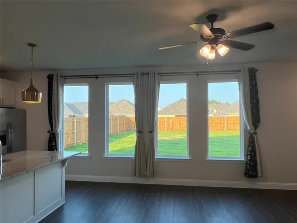 a living room with hardwood floor and windows