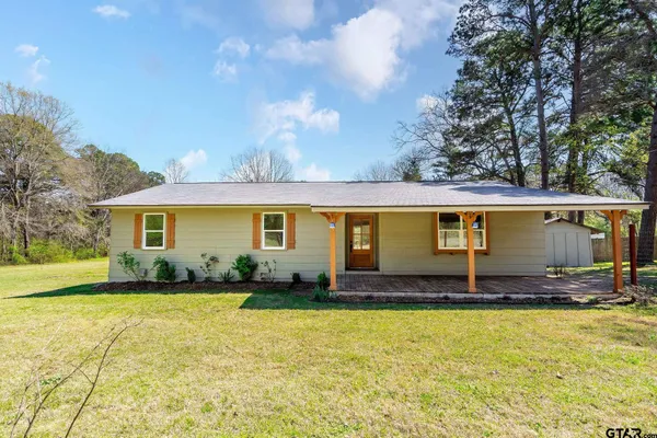 a front view of house with yard outdoor seating and barbeque oven