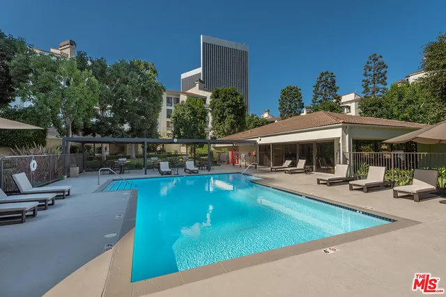 a view of a swimming pool with chairs in patio