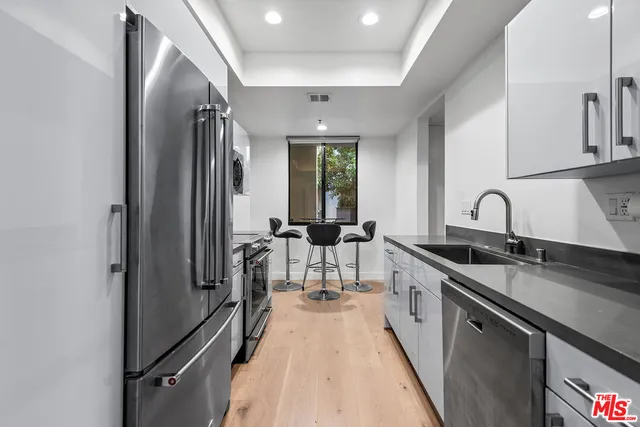 a spacious bathroom with a double vanity sink a mirror and a bathtub