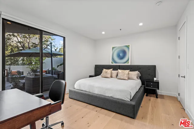 a bedroom with a large bed and a large window