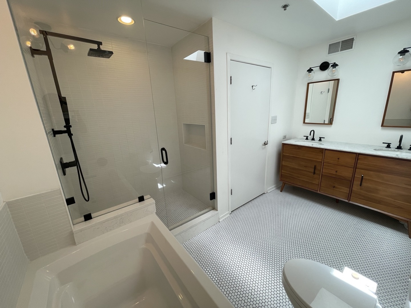 14 North Sangamon Street, Unit 403 Chicago, IL 60607 - Photo 12 of 18 a bathroom with a tub sink and mirror