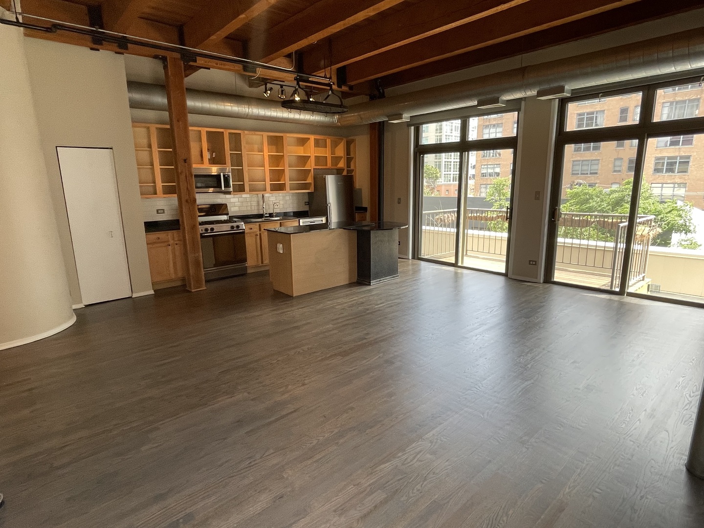 14 North Sangamon Street, Unit 403 Chicago, IL 60607 - Photo 3 of 18 a view of open kitchen with wooden floor and large window