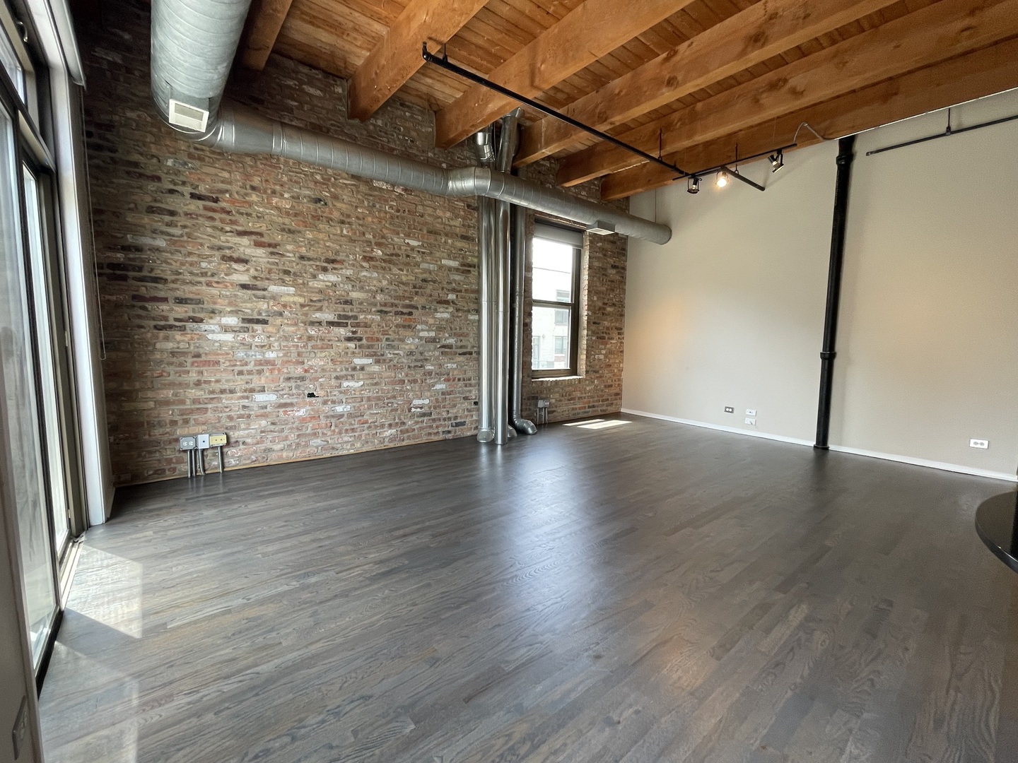 14 North Sangamon Street, Unit 403 Chicago, IL 60607 - Photo 4 of 18 an empty room with wooden floor and windows