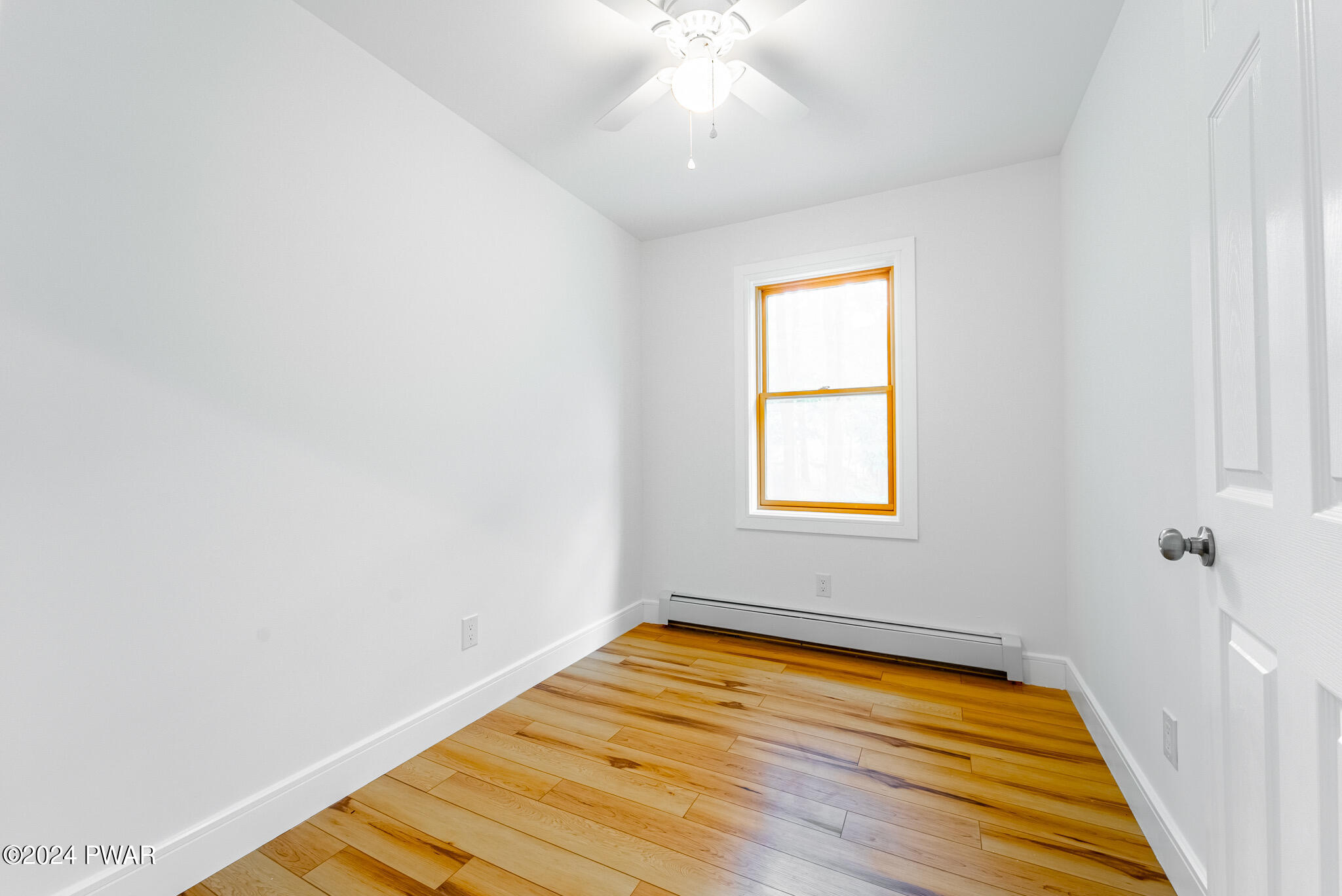 144 Log Tavern Road Milford, PA 18337 - Photo 42 of 45 a view of an empty room with wooden floor and a window