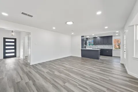 a view of a kitchen with a sink and wooden floor