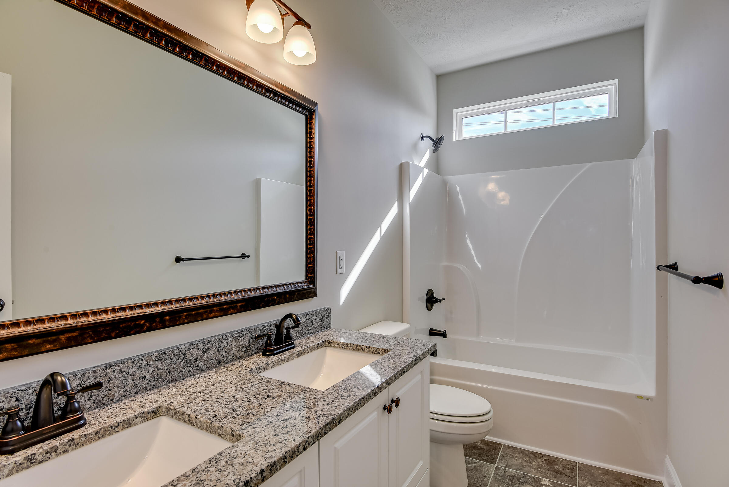 22 Orchard Circle Edgefield, SC 29824 - Photo 6 of 11 a bathroom with a granite countertop sink a toilet and a mirror