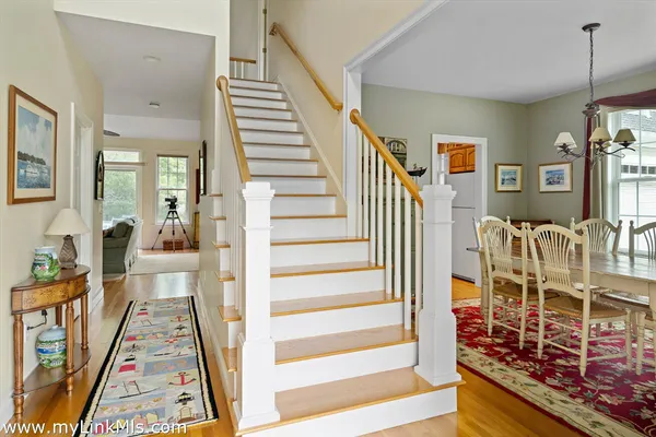 a view of a hallway with wooden floor and windows