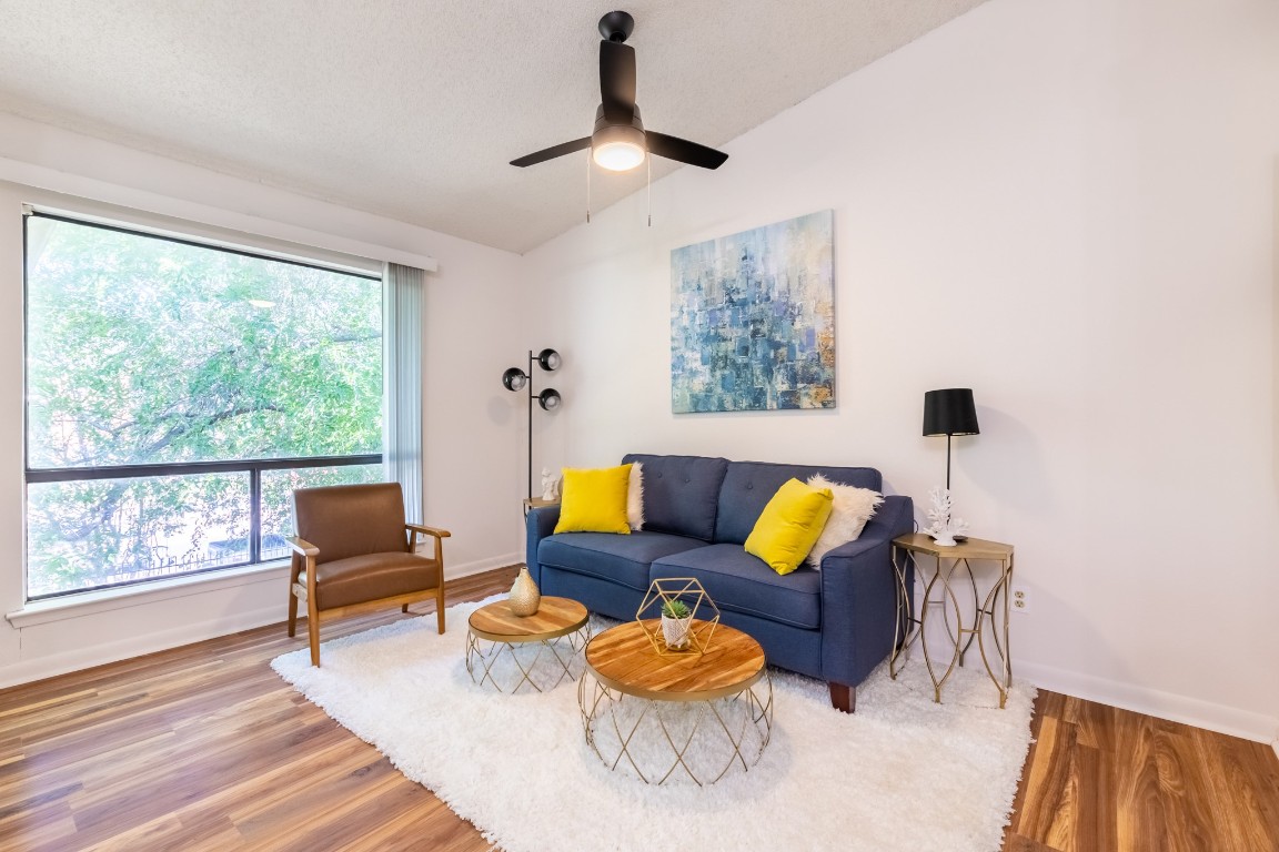 a living room with furniture and wooden floor