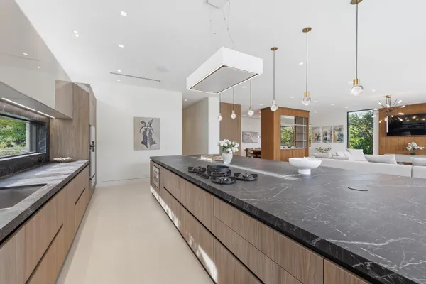 a kitchen with counter top space and living room view