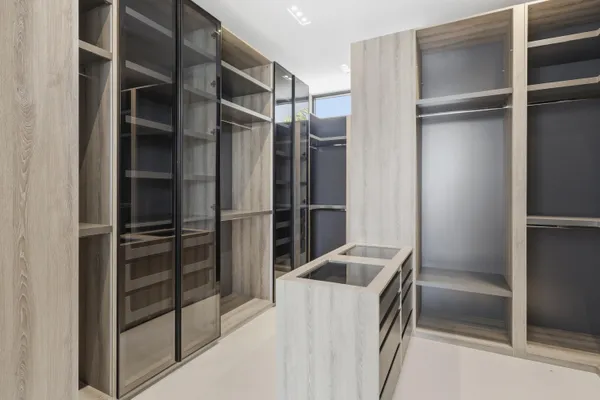 a view of walk in closet with empty racks
