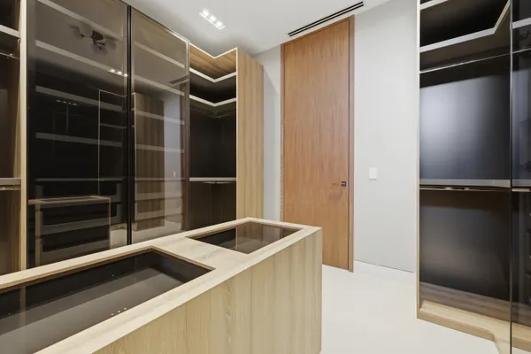 a view of a living room with a floor to ceiling window and kitchen