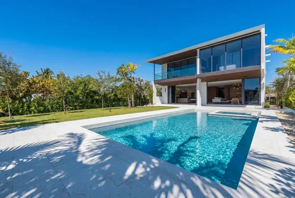 a view of a house with backyard and sitting area