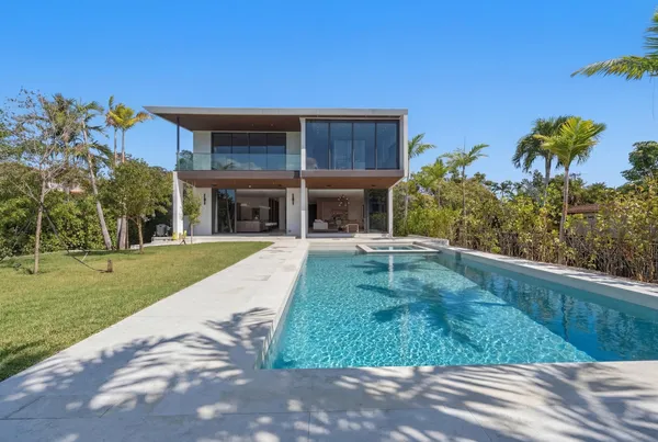a swimming pool with outdoor seating and yard