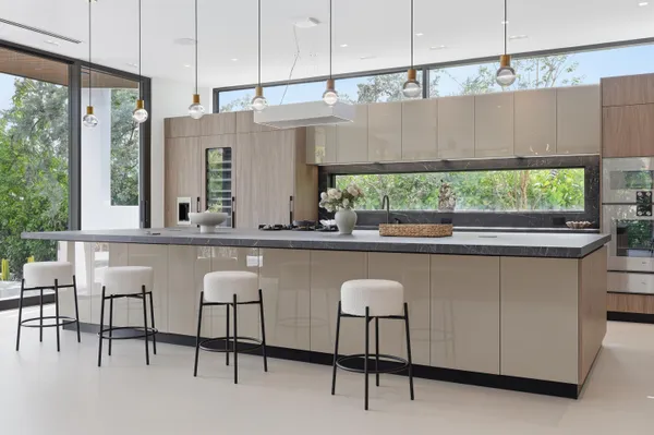 a kitchen with a table chairs and a large window