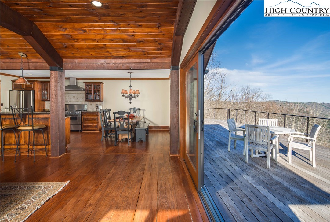 260 Beacon Hill Blowing Rock, NC 28605 - Photo 13 of 47 a dining room with furniture wooden floor and a chandelier