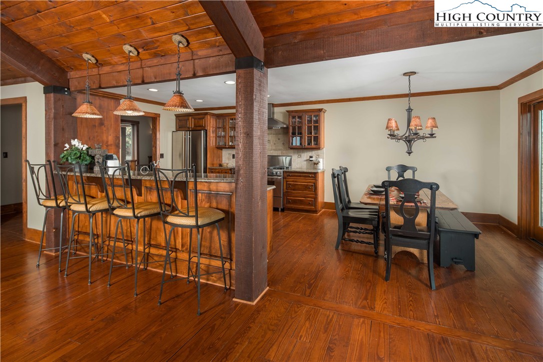 260 Beacon Hill Blowing Rock, NC 28605 - Photo 17 of 47 a dining room with furniture wooden floor and chandelier