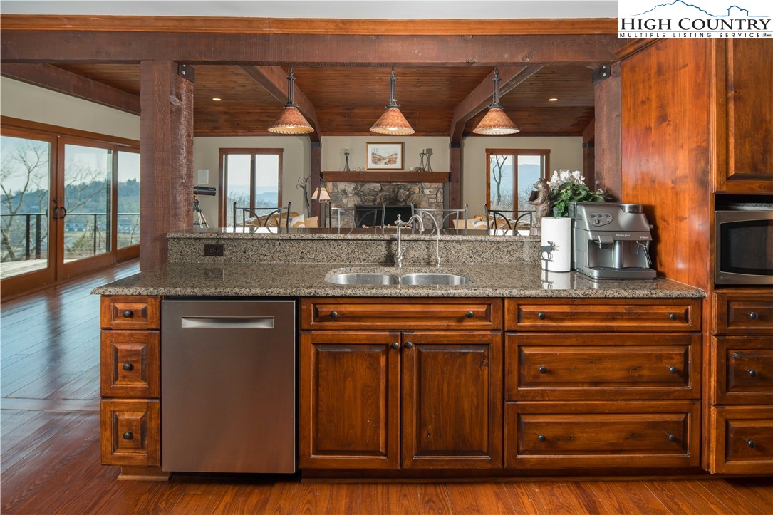 260 Beacon Hill Blowing Rock, NC 28605 - Photo 19 of 47 a kitchen with stainless steel appliances granite countertop a sink and wooden cabinets