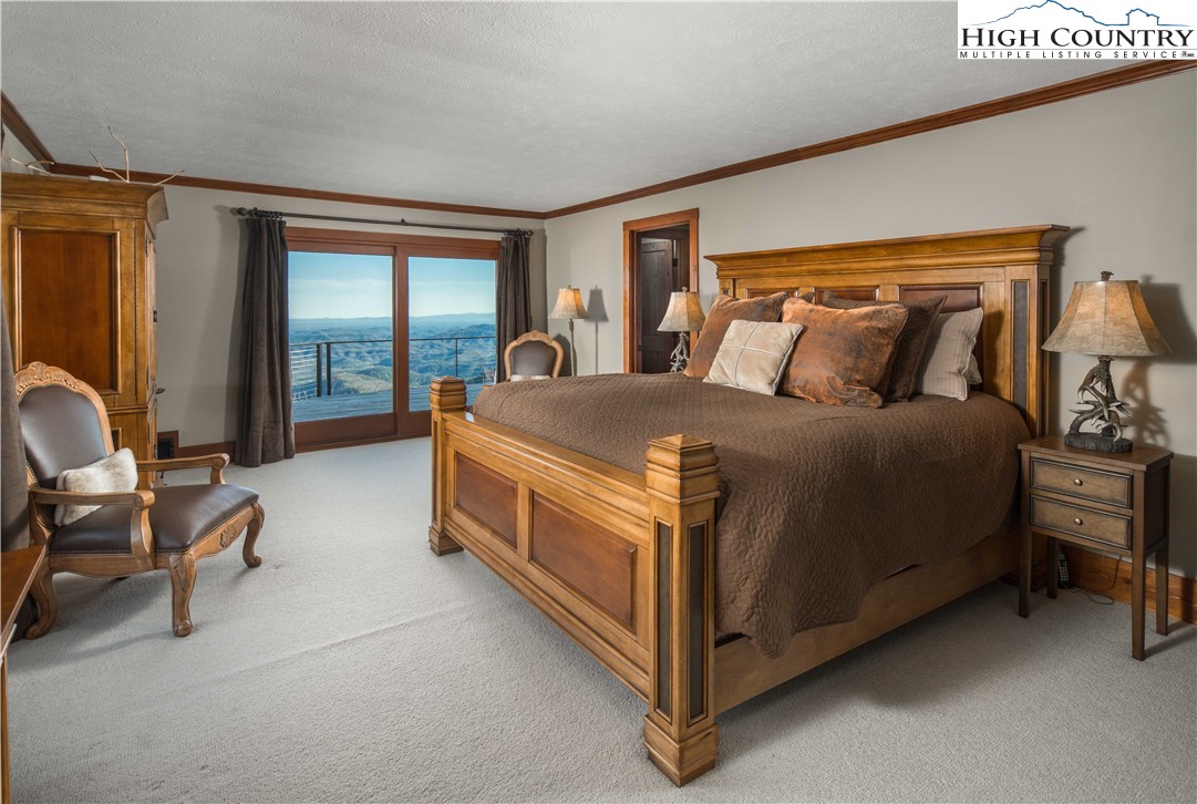 260 Beacon Hill Blowing Rock, NC 28605 - Photo 24 of 47 a bed room with a bed and a chair