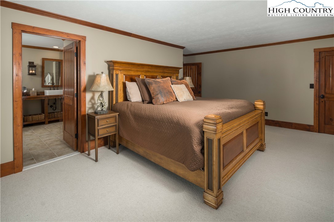 260 Beacon Hill Blowing Rock, NC 28605 - Photo 25 of 47 a bed sitting in a room next to a window