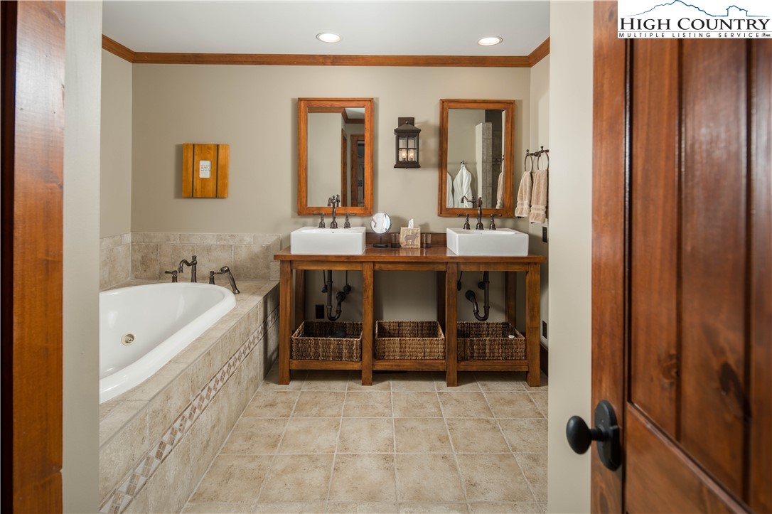 260 Beacon Hill Blowing Rock, NC 28605 - Photo 26 of 47 a bathroom with a tub sink and mirror