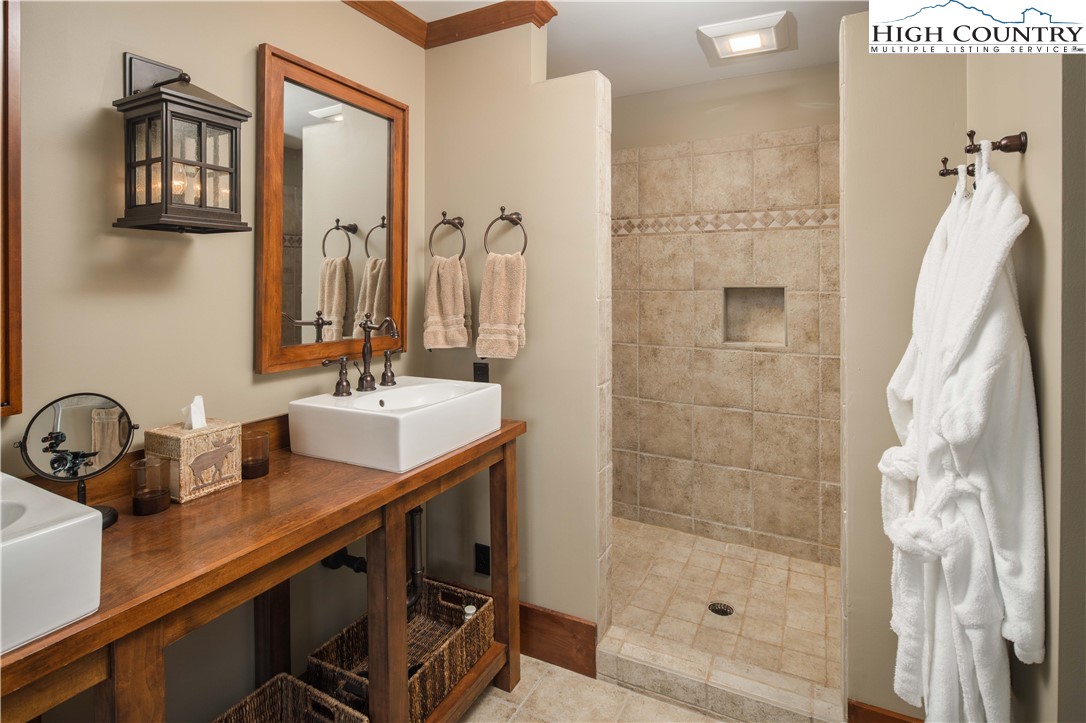 260 Beacon Hill Blowing Rock, NC 28605 - Photo 28 of 47 a bathroom with a sink and a mirror