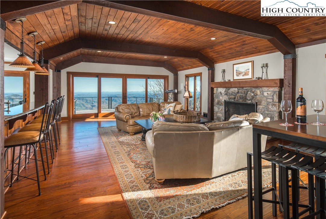 260 Beacon Hill Blowing Rock, NC 28605 - Photo 9 of 47 a living room with furniture a fireplace and a floor to ceiling window