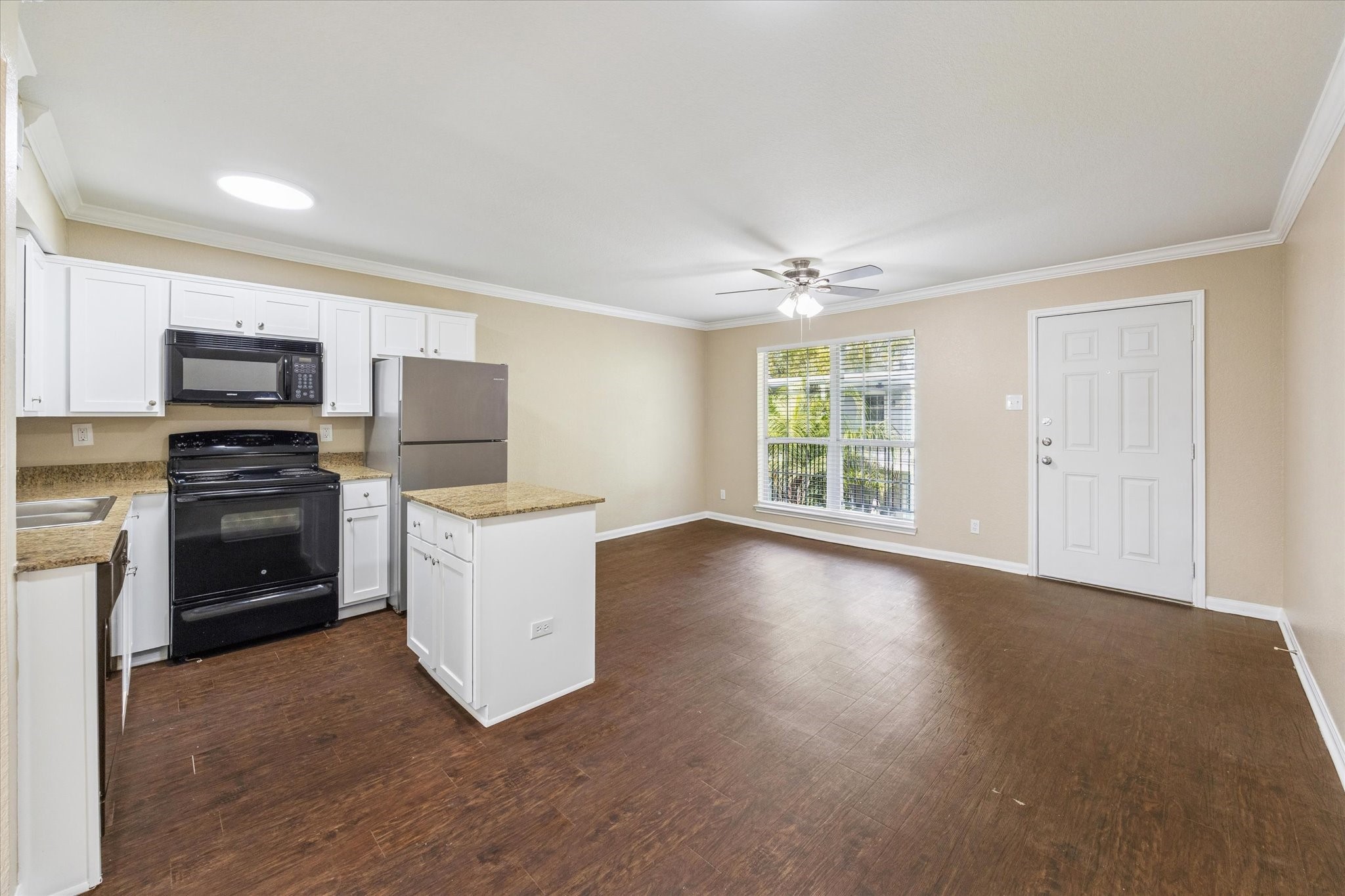 a kitchen with a stove a refrigerator and a sink