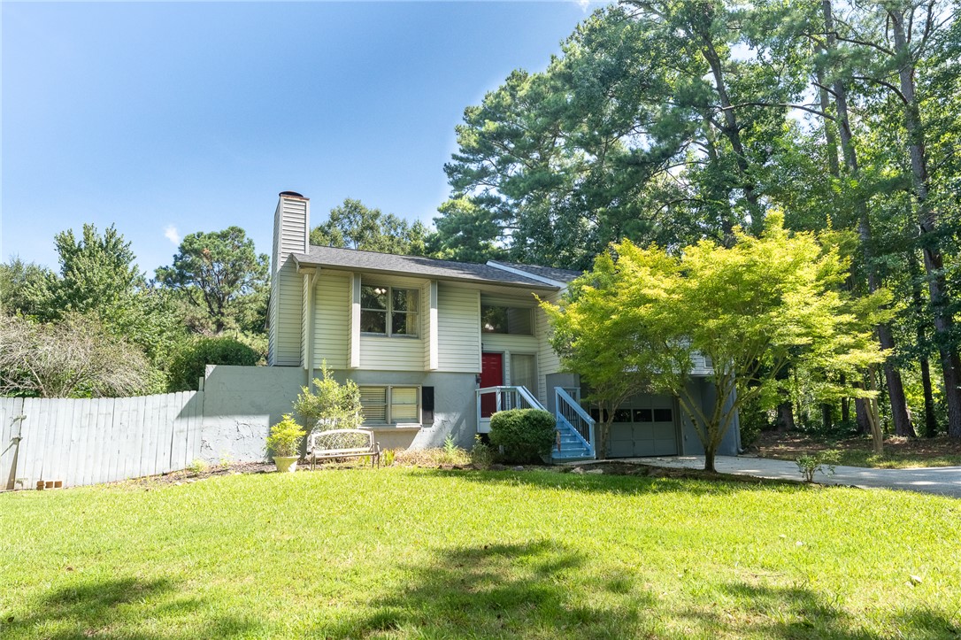117 Shaftsbury Road Clemson, SC 29631 - Photo 1 of 29 Mature trees frame a multi-level home featuring wood siding and an integrated garage.