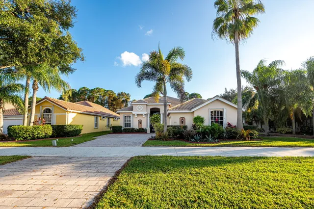 a front view of a house with a garden and yard