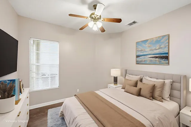 a bedroom with a large bed and a window