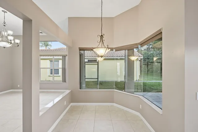 a view of a porch with chairs and backyard