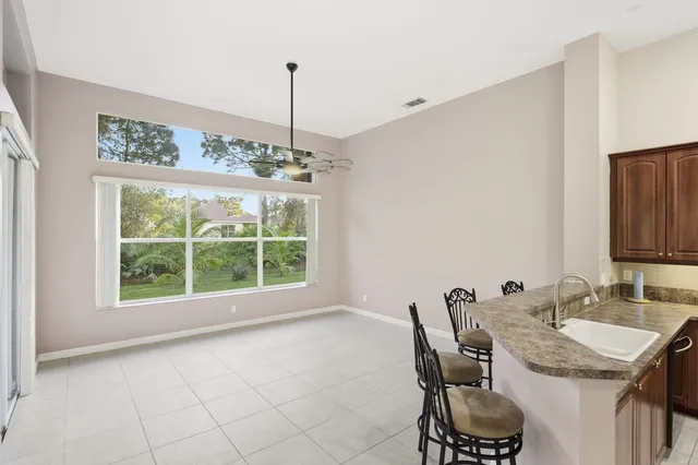 a view of a dining room with furniture window and outside view