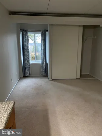 a view of a livingroom with kitchen and furniture