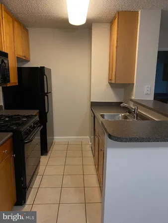 a kitchen with a sink and a stove top oven