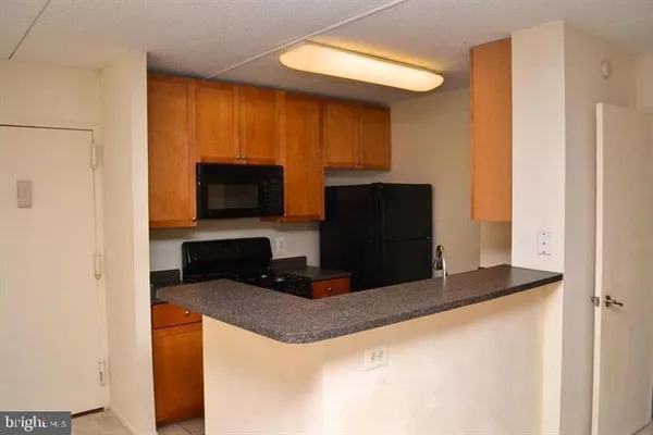 a kitchen with stainless steel appliances a refrigerator and a microwave