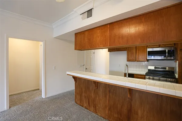 a kitchen with stainless steel appliances a sink and a refrigerator