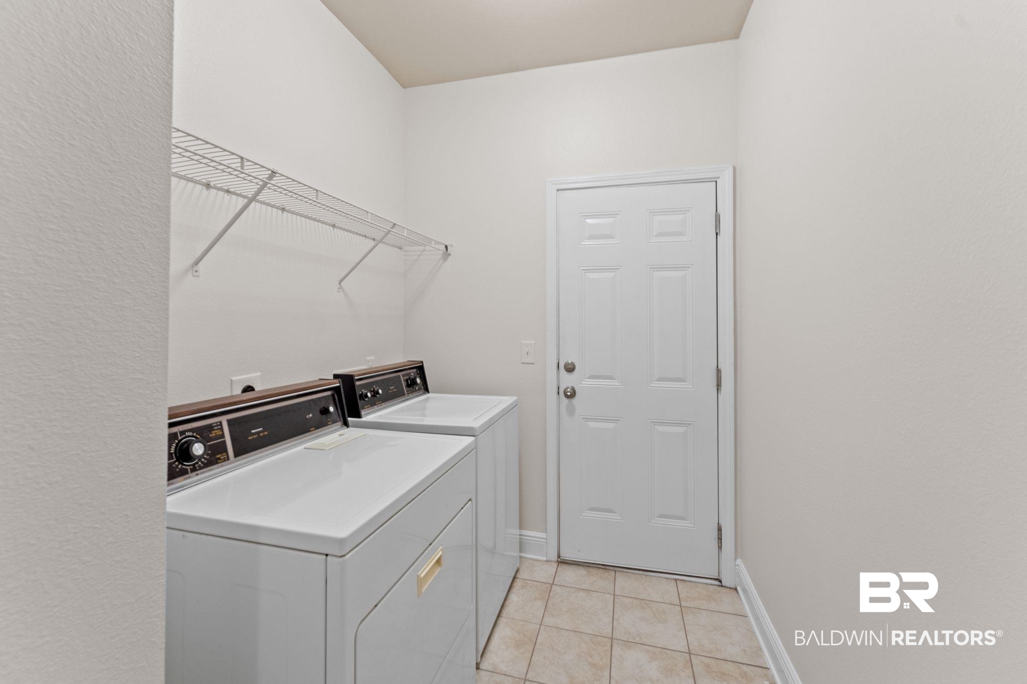1464 Surrey Loop Foley, AL 36535 - Photo 22 of 24 Laundry room featuring separate washer and dryer and light tile patterned flooring