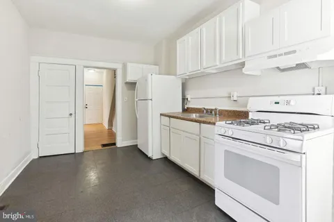 a kitchen with cabinets and white appliances