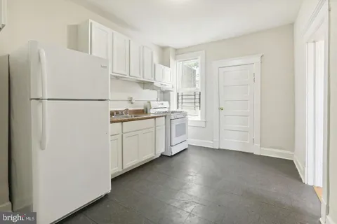 a white refrigerator freezer sitting in a kitchen