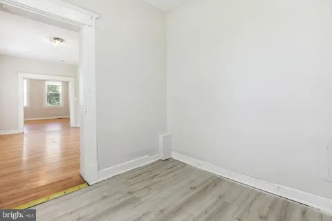 a view of a room with wooden floor