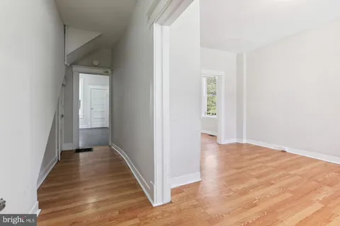 a view of a hallway with wooden floor