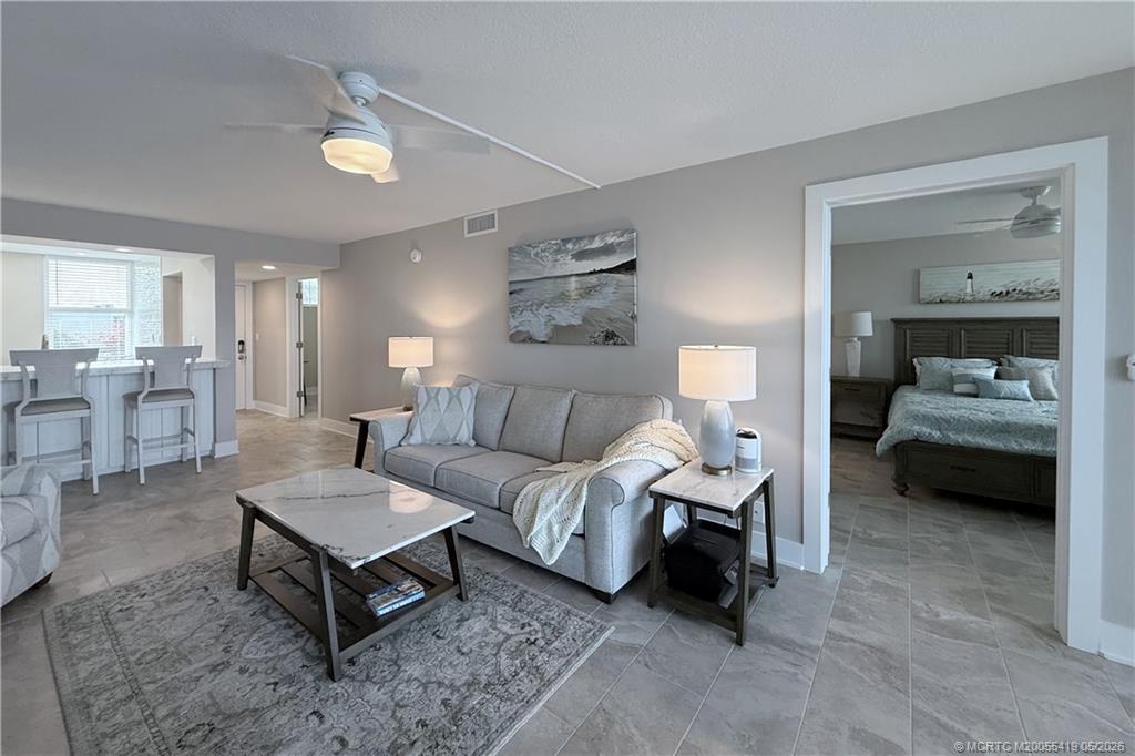 1950 Southwest Palm City Road, Unit 14305 Stuart, FL 34994 - Photo 30 of 70 a living room with furniture and a table